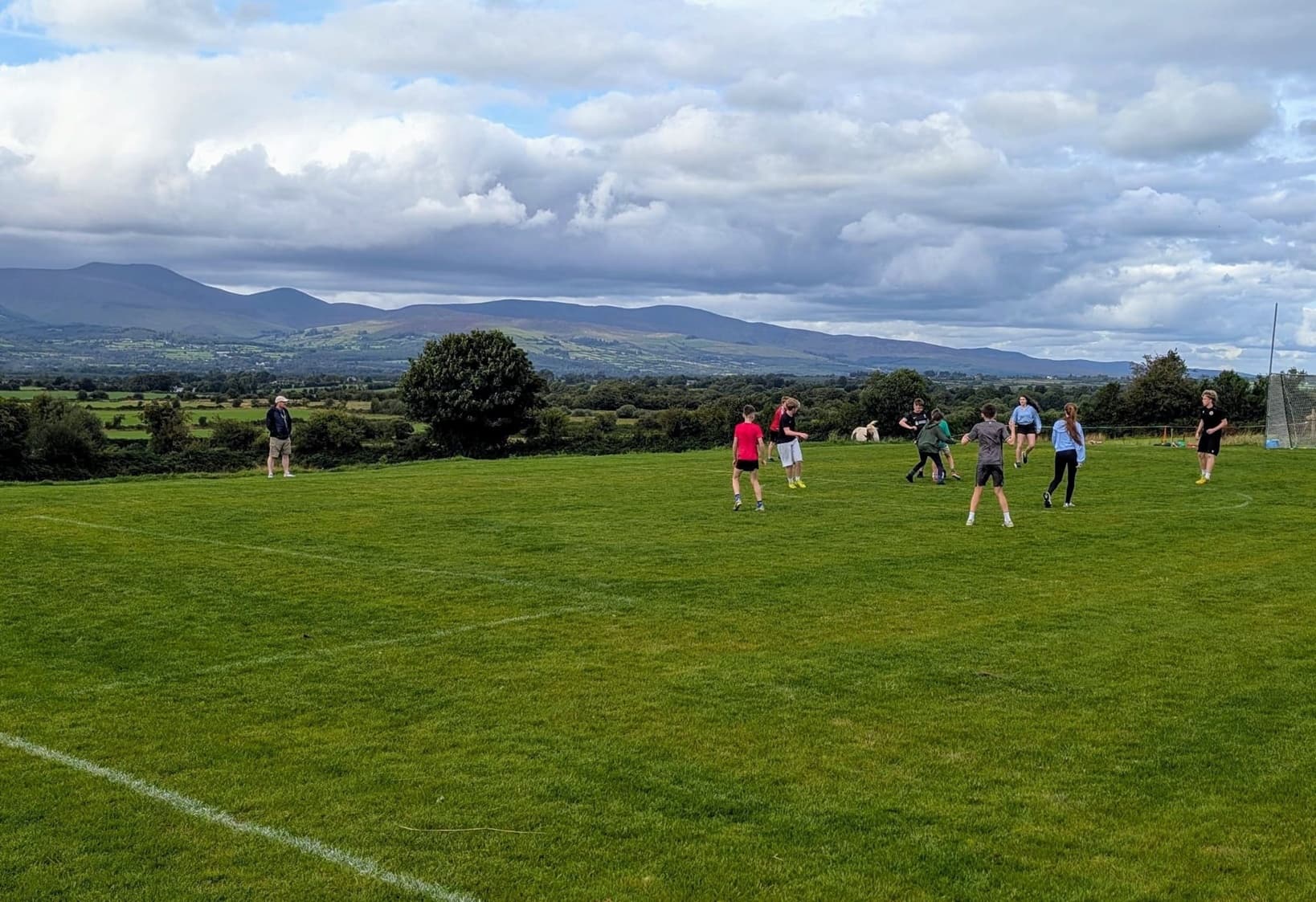 Kids playing football with mountain views